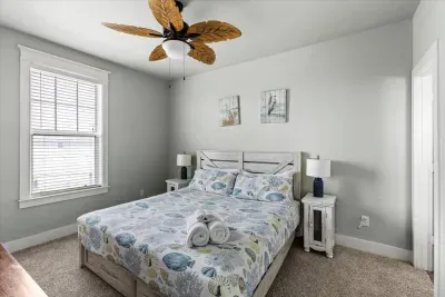 Calming colors and coastal decor create a restful escape in this king-sized bedroom.