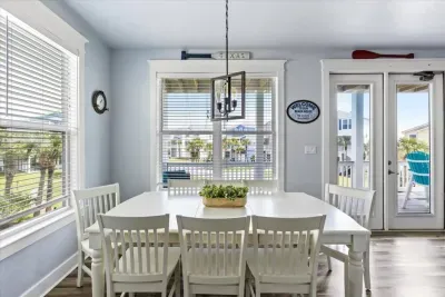 Bright and breezy dining room space with plenty of seating - perfect for family meals and game nights. 