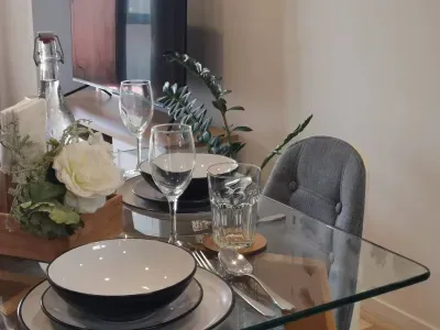 Cutlery, plates, wine glasses + comfy chairs around a sturdy table. Perfect for intimate dinners or game nights.