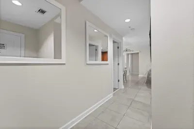 Freshly updated hallway with clean lines and modern coastal décor.
