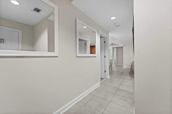 Freshly updated hallway with clean lines and modern coastal décor.