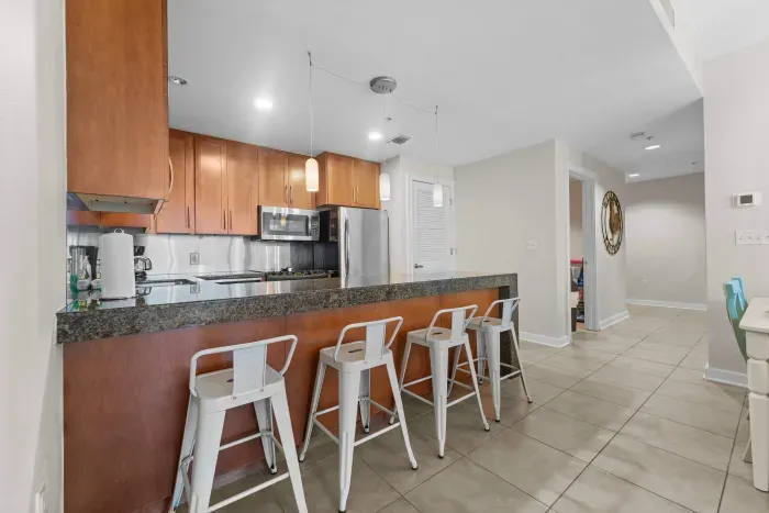 Modern kitchen with granite countertops and sleek stainless-steel appliances.
