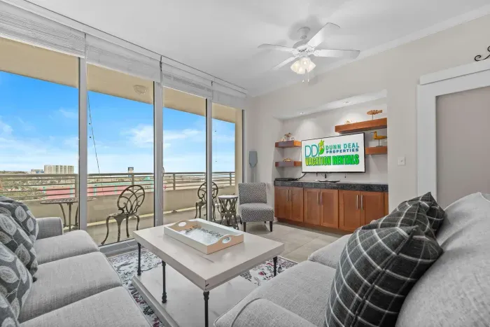Spacious living room featuring plush seating and Gulf-inspired artwork.