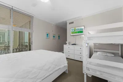 Spacious bedroom with elegant décor and calming tones ideal for families seeking a stylish and restful stay.