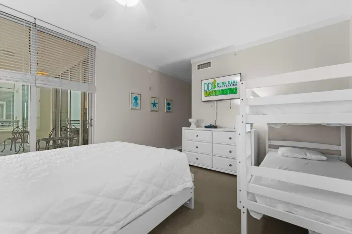 Spacious bedroom with elegant décor and calming tones ideal for families seeking a stylish and restful stay.