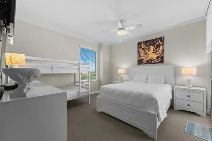 Bright and serene bedroom offering plush comfort and peaceful morning light perfect for a relaxing coastal escape.