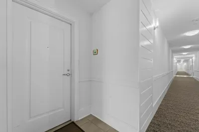 Bright hallway with modern finishes leading to the main living areas.