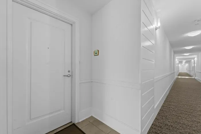 Bright hallway with modern finishes leading to the main living areas.