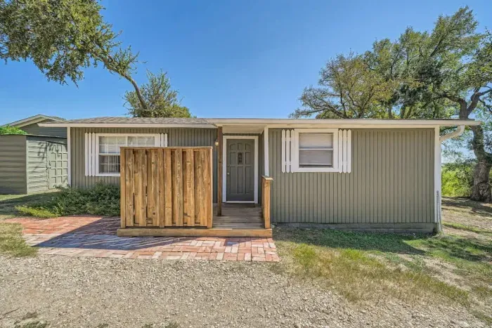 This cozy home greets you with a welcoming porch and simple, relaxed style