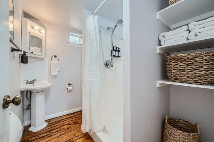 A refreshing, clean bathroom with charming decor and all the essentials.