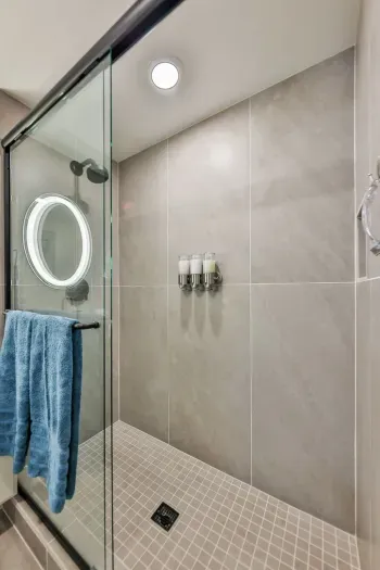 Relax in the full bathroom adorned with elegant tilework and spa-inspired touches.