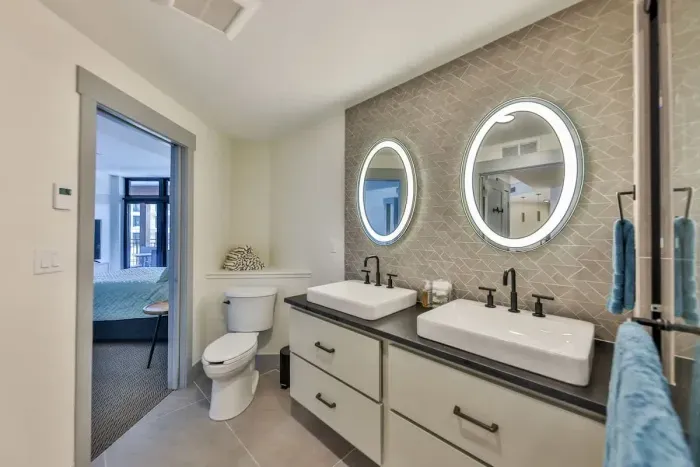 Unwind in the impeccably designed bathroom featuring upscale mirrors and refined fixtures.