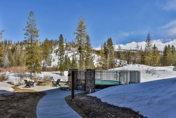 A serene pathway leading to the outdoor fire pit surrounded by breathtaking scenery.