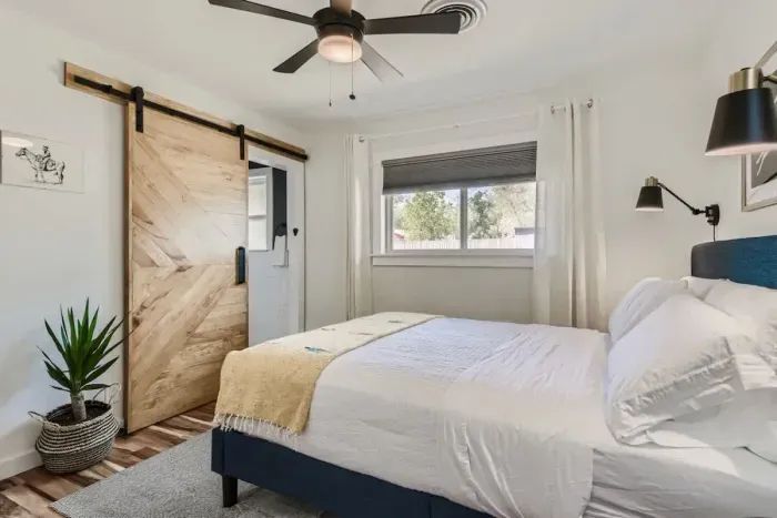 Spacious primary bedroom with a queen-sized bed and an en-suite bathroom.