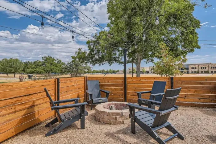Enjoy the amazing outdoor space in the front, featuring a cozy fire pit surrounded by comfortable chairs. Perfect for evening relaxation, this inviting setup offers warmth and ambiance for memorable gatherings.