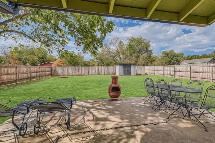 Private patio with lush plants and a calming atmosphere, perfect for unwinding after a long day.