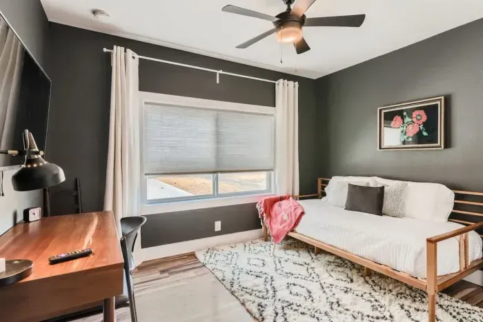 Functional and stylish bedroom with a desk for remote work or study.