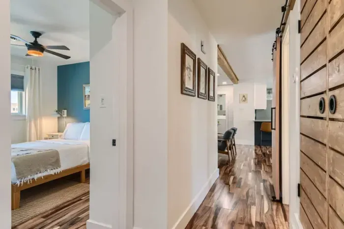 Charming hallway connecting three bedrooms, offering easy access and a flow of natural light. The spacious corridor provides a seamless transition between rooms, enhancing the home's inviting and open layout.