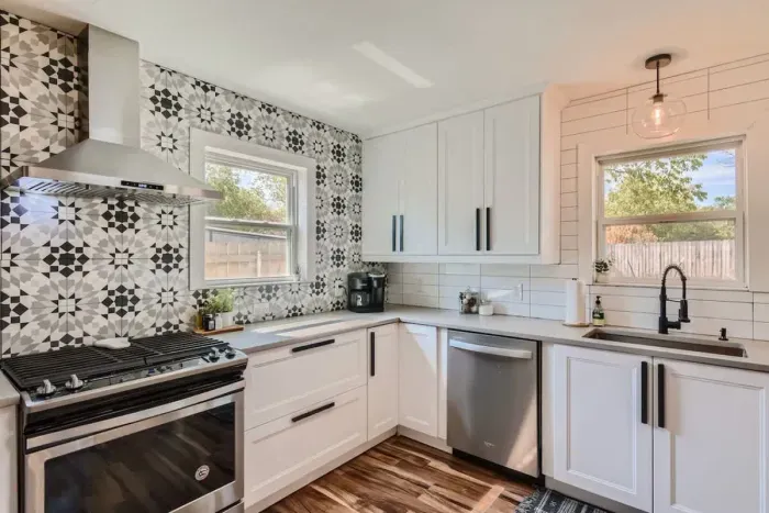 Step into the remodeled kitchen, featuring elegant cream-colored tiles with a unique catcher's design. The modern upgrades and stylish details create a warm and inviting space, perfect for cooking and entertaining.