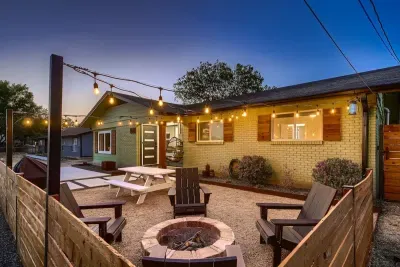 Cozy backyard retreat with string lights, a fire pit, and comfortable seating.