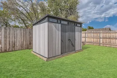 Convenient outdoor shed, perfect for storing tools, garden supplies, or outdoor equipment. This practical space helps keep the yard organized while blending seamlessly into the surroundings.