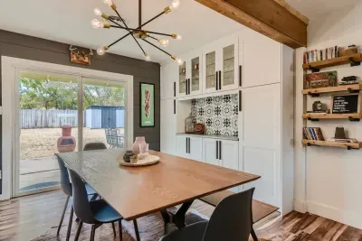 Bright and airy dining area with large windows and cozy seating for memorable meals.
