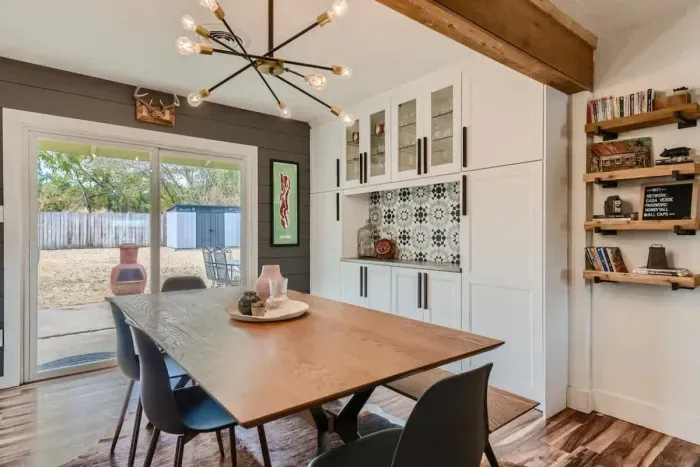 Bright and airy dining area with large windows and cozy seating for memorable meals.