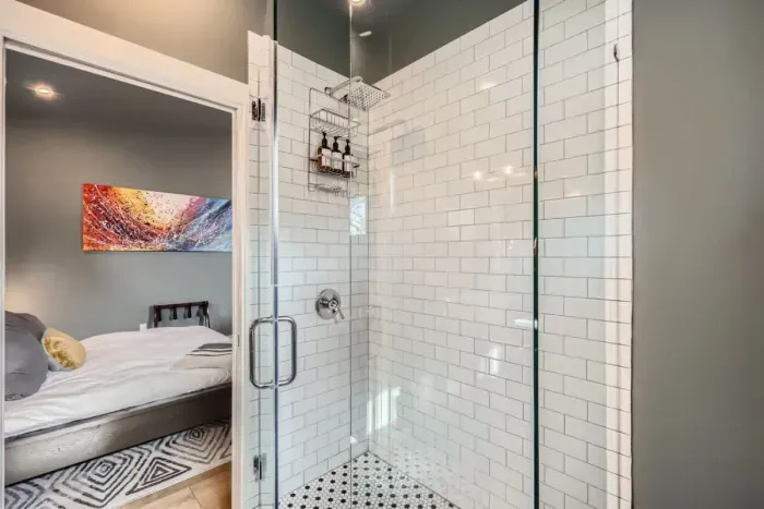 Modern full bathroom with walk-in glass shower, subway tile, and fresh linens for a spa-like feel.