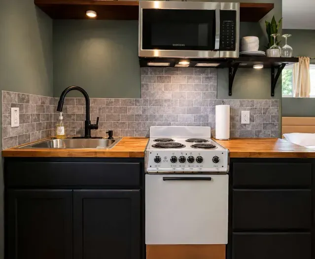 Enjoy the convenience of a fully equipped kitchen featuring a cooktop, sink, ample counter space, and everything you need to prepare meals during your stay