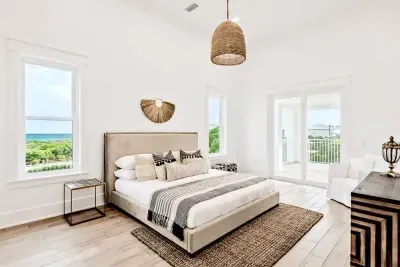 Natural light floods this charming room, complete with a queen-size bed and stylish furniture, making it the perfect spot for a peaceful stay.