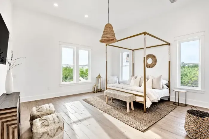 Wake up refreshed in this serene bedroom featuring a dreamy four-poster bed, layered with natural textures and soothing earthy hues