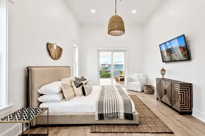 A serene and spacious bedroom featuring a cozy king sized bed, natural textures, and soft, earthy tones.