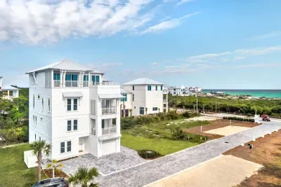 Soak in stunning coastal views from this modern multi-level beach retreat. With bright white architecture, spacious balconies, and just steps from the shoreline, this home offers the perfect blend of style and seaside living.