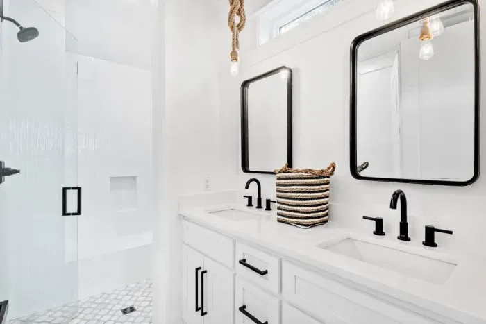 Spacious bathroom with dual sinks land stylish mirrors for added convenience.
