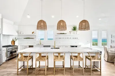 4. Spacious kitchen with a large island and seating, ideal for enjoying morning coffee or group meal prep.
