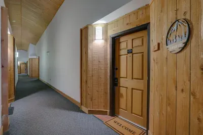 A cozy, well-lit entryway that enhances the cabin feel throughout the condo.