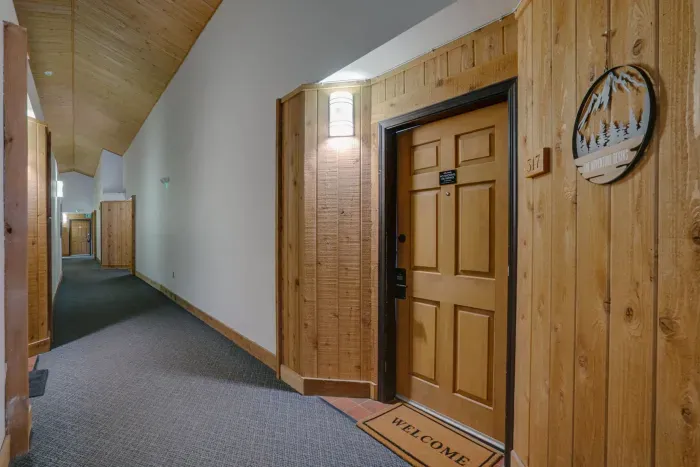 A cozy, well-lit entryway that enhances the cabin feel throughout the condo.