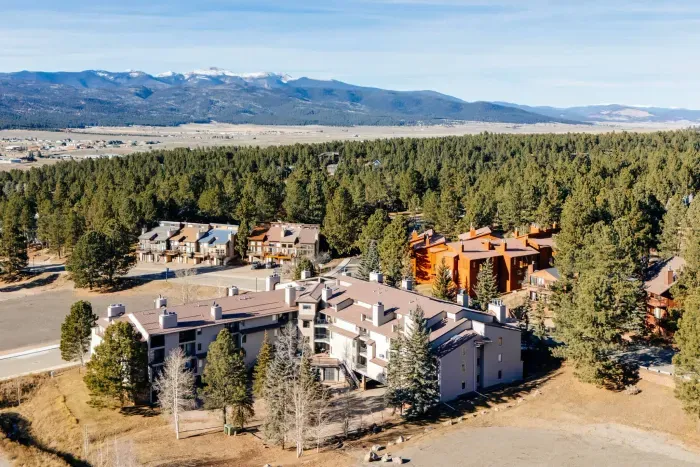 Stunning alpine scenery with forested peaks and bright New Mexico skies.