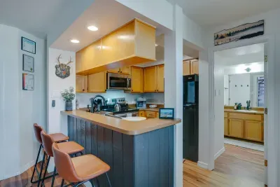 A fully equipped kitchen with stainless appliances, warm cabinetry, and everything needed for cooking in the mountains.