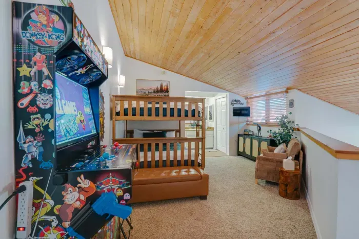 A beautifully styled guest bedroom offering warm wood accents and a serene mountain-cabin feel for a peaceful Angel Fire getaway.