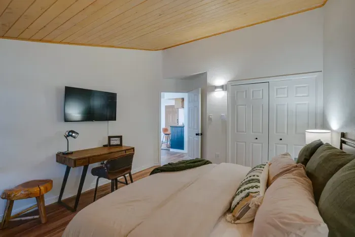 Elegant master bedroom featuring cozy textures and warm cabin-style architecture.