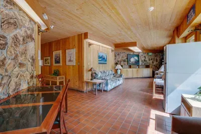 A charming common space with stone accents, warm lighting, and rustic resort style.