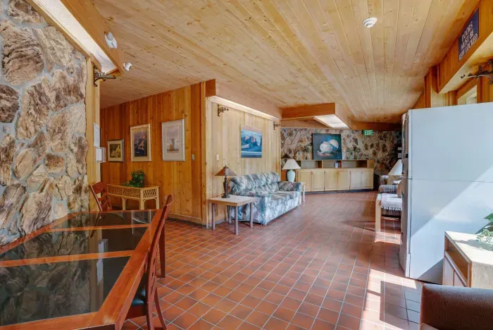 A charming common space with stone accents, warm lighting, and rustic resort style.