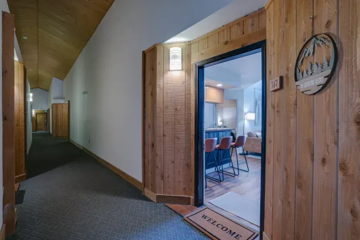 Gather around this cozy dining area, complete with modern lighting, natural textures, and an inviting open layout perfect for shared meals.