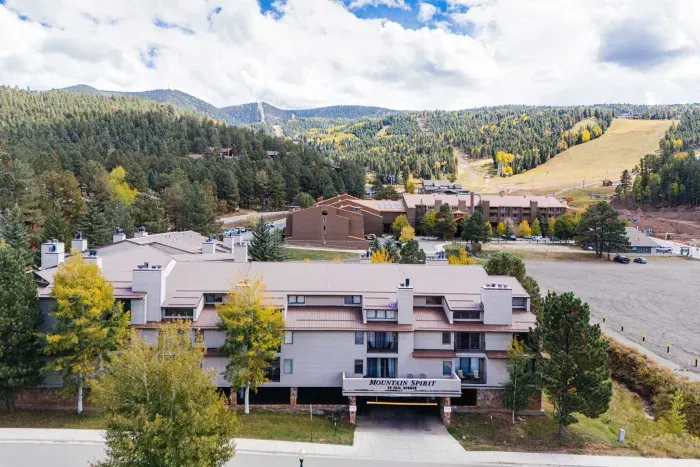 A warm and inviting mountain retreat framed by fall colors.