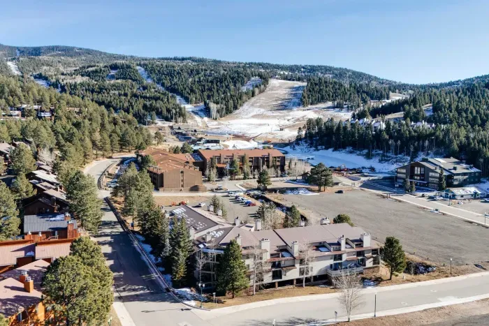 Sweeping aerial-style perspective highlighting the resort and valley.