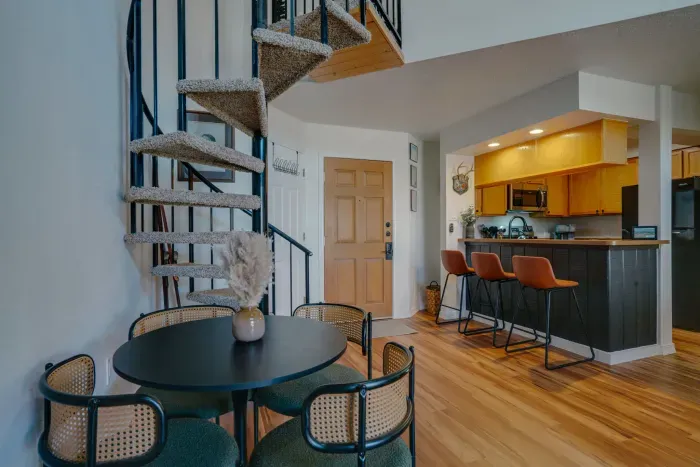 A striking architectural feature that connects the main level to additional lounging and sleeping spaces, enhancing the cabin-style atmosphere.