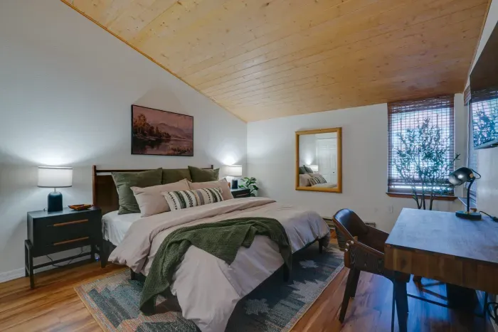 A beautifully appointed primary suite with soft lighting and mountain-chic comfort.