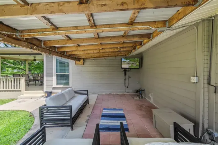 Elegant patio with a stylish outdoor dining set and a beautiful view, perfect for hosting guests.