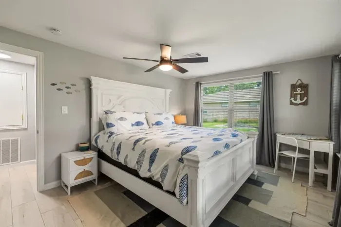 Secondary Bedroom with King. Perfect working desk for make up or a working from home. Features Blackout Curtains, phone chargers and a fan.
